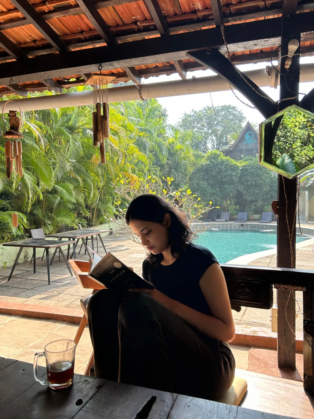 Woman reading quietly by the pool
